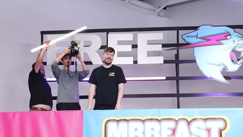 A camera operator and crew filming MrBeast on a studio set lit by LED tubes